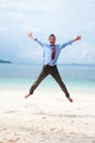 Funny business man jumping on the beach Royalty Free Stock Photo