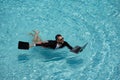 Funny business man relaxing in suit on swimming pool. Summer vacation, business on sea beach. Summer rest, business Royalty Free Stock Photo