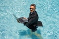 Funny business man relaxing in suit on swimming pool. Summer vacation, business on sea beach. Summer rest, business Royalty Free Stock Photo