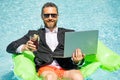 Funny business man in a business suit floating in the water in the pool. Remote work. Crazy freelancer. Business and Royalty Free Stock Photo