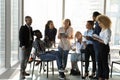 Positive young ethnic staff group meeting at break having fun Royalty Free Stock Photo