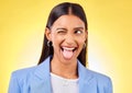 Funny, business woman and crazy worker with silly and tongue out in a studio. Happy, female person and yellow background