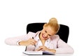 Funny business woman taking notes behind the desk Royalty Free Stock Photo