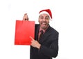 Funny businessman in Christmas Santa hat holding red shopping bag in December and New year sale Royalty Free Stock Photo