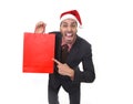 Funny businessman in Christmas Santa hat holding red shopping bag in December and New year sale Royalty Free Stock Photo