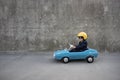 Funny businessman driving retro pedal car outdoor Royalty Free Stock Photo