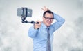 Funny businessman in glasses making selfie with a stick Royalty Free Stock Photo