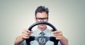 Funny businessman in glasses with a steering wheel