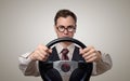 Funny businessman in glasses with a steering wheel Royalty Free Stock Photo