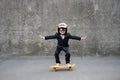 Funny businessman riding skateboard outdoor