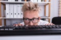 Funny Businessman Hiding Behind Desk Royalty Free Stock Photo