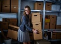 Funny businesswoman holding storage boxes