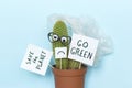 Funny cactus and plastic rubbish