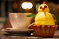 Funny cake in the shape of a yellow chicken with a decoration of