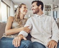 Funny, care and couple on the sofa to relax with love, smile and gratitude in living room. Happiness, laughing and happy Royalty Free Stock Photo