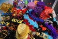 Funny carnival hats, glasses, masks and feathers piled on the tabletop