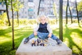 Funny Caucasian baby girl blonde does not want learn, does not want to school, want to play, laugh and indulge. child with hair