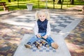 Funny Caucasian baby girl blonde does not want learn, does not want to school, want to play, laugh and indulge. child with hair