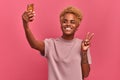 Funny cheerful african-american girl student taking selfie using smartphone Royalty Free Stock Photo