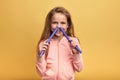 Funny cheerful happy girl having fun, putting her hair-curlers into her nose Royalty Free Stock Photo