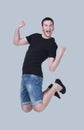 Funny cheerful happy man jumping in air over gray background Royalty Free Stock Photo