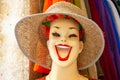 Funny cheerful mannequin head wearing hat in store