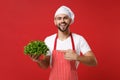 Funny chef cook or baker man in striped apron white t-shirt toque chefs hat isolated on red background. Cooking food Royalty Free Stock Photo