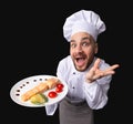 Funny Chef Offering Salmon Dish On Plate, Studio Shot, High-Angle Royalty Free Stock Photo