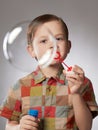 Funny child blowing soap bubbles Royalty Free Stock Photo