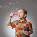 Funny child blowing soap bubbles. little boy Royalty Free Stock Photo
