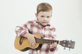 Funny child boy with guitar.fashionable country boy playing music Royalty Free Stock Photo