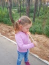 Funny child with candy lollipop, happy little girl eating big sugar lollipop, kid eat sweets. surprised child with candy Royalty Free Stock Photo