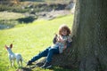 Funny child with dog walking at spring lawn in the park outdoor. Kids insurance. Pretty little cute child baby boy, play