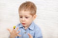 Funny child drawing with fingers in album using special paint