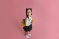 Funny child, early education and school life. Happy girl in uniform with backpack