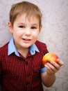 Funny Child eating apple. Little Handsome Boy with green apple. Health food. Fruits. Enjoy Meal