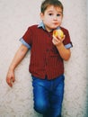 Funny Child eating apple. Little Handsome Boy with green apple. Health food. Fruits. Enjoy Meal