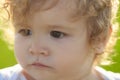 Funny child face close up. Kids baby serious portrait.