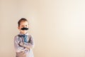 Funny child with fake mustache gesturing like an adult man, maturity and business concept Royalty Free Stock Photo