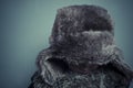 Funny child with fur hat and winter coat, cold concept and storm Royalty Free Stock Photo