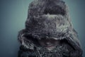 Funny child with fur hat and winter coat, cold concept and storm Royalty Free Stock Photo