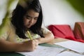 A funny child girl doing homework writing Royalty Free Stock Photo