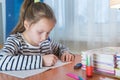 a funny child girl doing homework writing and reading at home Royalty Free Stock Photo