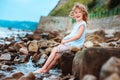 Funny child girl playing with water splash on the beach. Traveling on summer vacation. Royalty Free Stock Photo