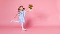 Funny child girl runs and jumps with bouquet of flowers on color Royalty Free Stock Photo