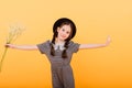 Funny child girl smiling with bouquet of flowers on a coloured background Royalty Free Stock Photo