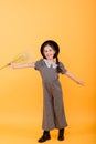 Funny child girl smiling with bouquet of flowers on a coloured background Royalty Free Stock Photo