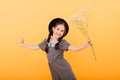 Funny child girl smiling with bouquet of flowers on a coloured background Royalty Free Stock Photo