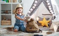 Funny child girl tourist with world map, backpack and magnifier Royalty Free Stock Photo