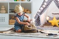 Funny child girl tourist with world map, backpack and magnifier Royalty Free Stock Photo